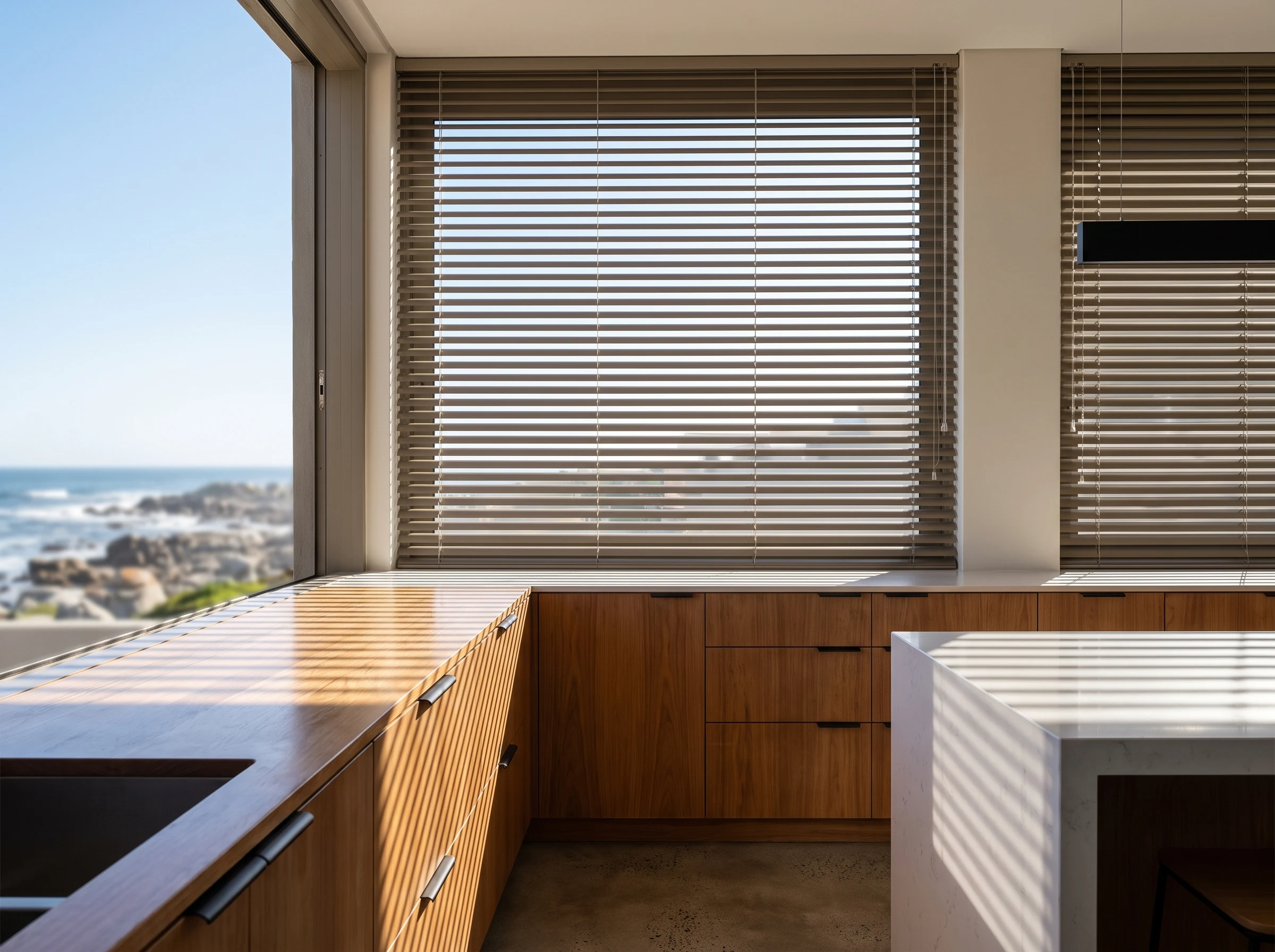 Aluminium venetian blind with tilted slats over a Sunningdale kitchen window with sea views